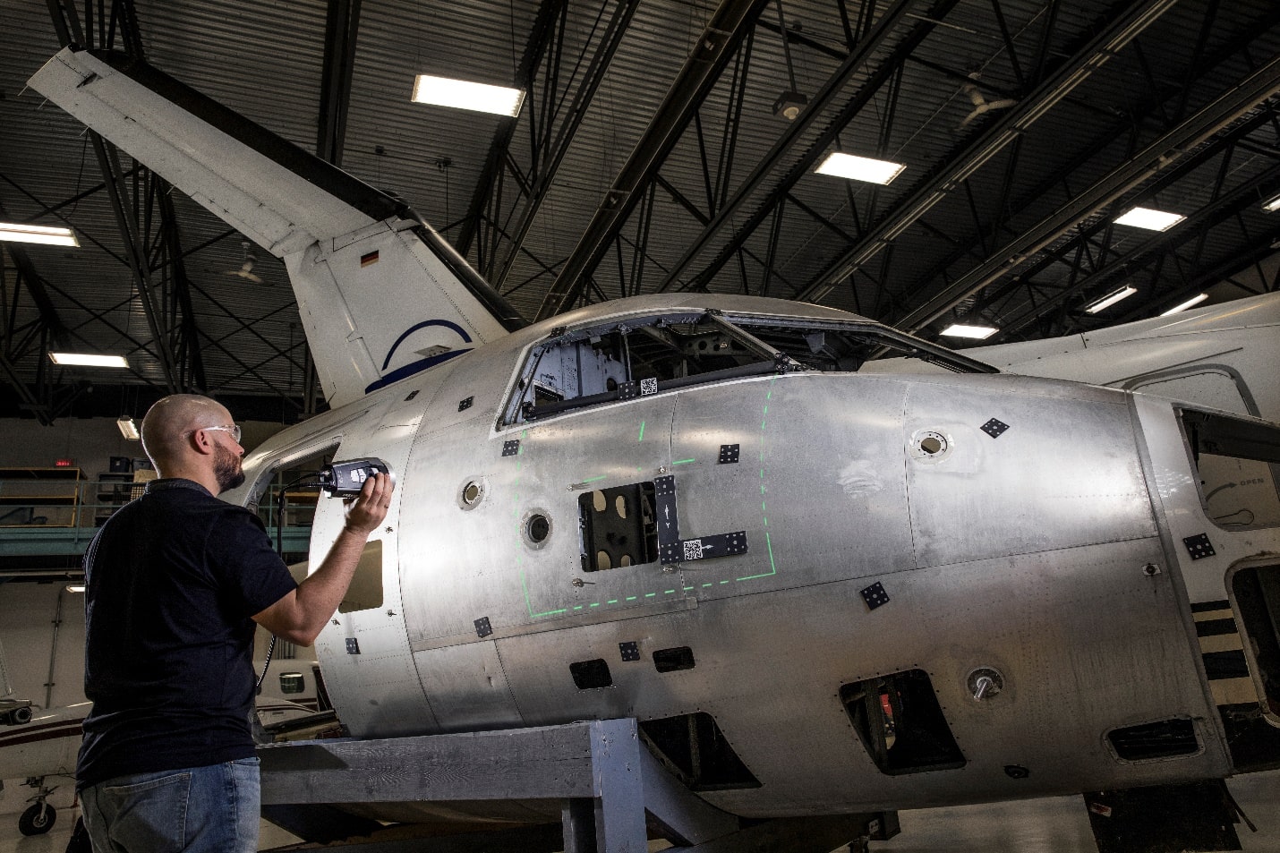 A person standing next to a plane Description generated with high confidence